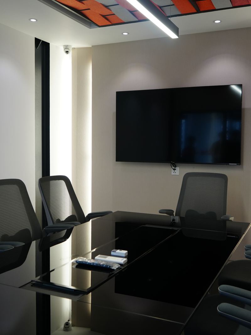 An enclosed meeting room at Girmairi with a security camera by the door