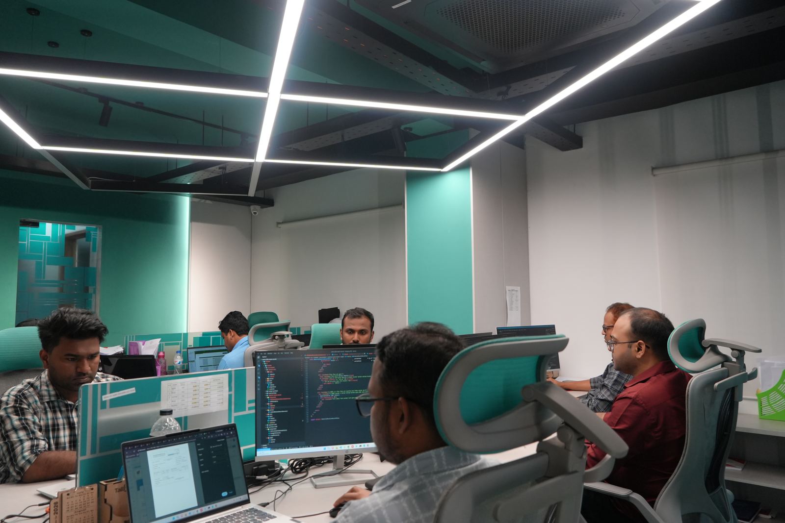 Girmairi engineers working on the floor of the Dhaka office
